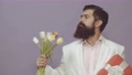 Funny Man With Bouquet Of Tulips And Gift For Birthday. Bearded Man Holds