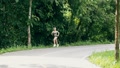 Young Woman Runner Listening Music On Headphones While Running On Road.