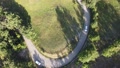 Aerial View Of A Car Going In A Turning Countryside Road