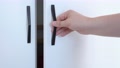 Man Holds Black Metal Handle With Hand And Carefully Closes Wardrobe Door, Close