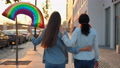 Two Lesbian Woman Lgbt Same-Sex Couple Hugging With Rainbow Symbol Balloon