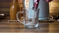 Pouring Instant Coffee Powder Into Glass Transperant Cup With Electric