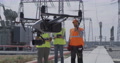 Engineers Launching Drone On Power Plant