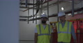 Engineers Walking And Talking Inside Power Plant