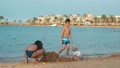 Cute Kids Building Sand Castle At Sea Bay. Happy Children Having Fun At Beach.