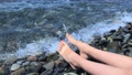 Legs And Feet Of A Child Sitting On A Pebble Sea Shore And Relaxing, Salt Water