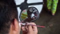 Close Up From The Mirror. A Man Decorates His Own Face