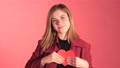 Cute Girl Shows Red Paper Hart To Camera Against Colourful Background