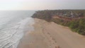 Backwarding Aerial Over Empty And Vacant Beach With Beautiful Cliffs