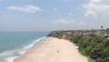 Forwarding Aerial Over Deserted Beach With Beautiful Cliffs During
