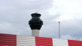 Airport Air Traffic Control Tower With Red And White Blast Fence Foreground