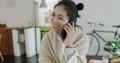 Lovely Young Asian Woman Talking On The Phone At Home