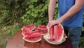 A Man Cuts A Pink-Fleshed Watermelon Into Slices.