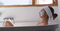 Woman Wearing Face Pack Relaxing In Bathtub