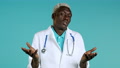 Portrait Of Unsure African Doctor In Professional Medical White Coat Shrugs His