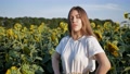 Young Pretty Woman Agronomist Standing On Background Of Field With Sunflowers
