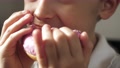 The Face Of A Little Boy. A Child Eats A Delicious Doughnut In Pink Icing. Food,
