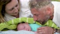 Newborn Baby Kissed By The Parents In The City Park, Slow Motion