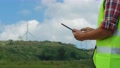 A Male Engineer Examining The Wind Turbine System