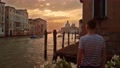 Gondolier Is Looking At Sunrise In Venice Near Grand Canal.