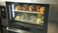 Croissants On Baking Sheet Are Baked In Oven. View Through Glass Door. Cooking
