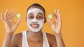Happy Black Man Poses For The Camera With A Cosmetic White Mask On His Face And