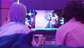Back View Of Young Couple Play Video Game Sackboy Little Big Planet On A Xiaomi