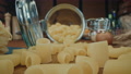 Close-Up Dolly Jar Of Raw Dried Organic Pasta Macaroni And Eggs On Wooden Table