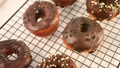Doughnut On The Baking Rack Glazed With Chocolate Cream Or Icing.