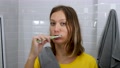Cute Female Brush Teeth In Bathroom