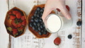 Pond5 Tasty fresh strawberry, bluebeery with milk sour cream or yogurt closeup, des