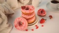 Stack Of Pink Doughnuts On The Plate. Valentine's Day Concept. Woman Hand Put A