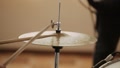 Close-Up Of Drummer Striking Cymbals With Wooden Ram Sticks