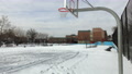 Schoolyard Playground Covered With Snow, No Kids. Basketball Hoop.