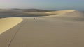 Drone Shot Of A Biker Cruising Through Sand Dunes In Brazil