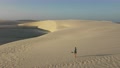Drone Shot Of A Lady Walking On Sand Dunes In Northern Brazil