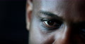 Close-Up Black Man Face And Eyes Looking At Laptop Computer Screen At Night