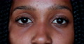 Close-Up Teen African Black Girl Eyes And Face Staring At Camera