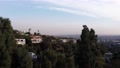 Aerial Rising Shot Through Trees Of Beverly Hills Mansions On Hillside. 4k