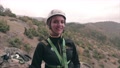 Female Climber With Climbing Equipment On Standing And Smiling.