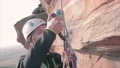 Female Climber Getting Ready To Climb On A Vertical Rock.