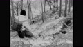 1960s: Boys Talk Into Wrist Radios And Play In Woods. Boys Climb Hill In Forest