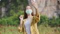 Thai Woman Wear Mask Taking A Selfie-And Vdo Call By Smartphone At Flower Field.